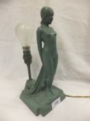 An Art Deco green painted lead figural table lamp inscribed to back "British made", with No. "