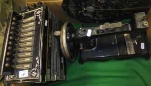 The National Band Accordion Model Deluxe and a vintage sewing machine