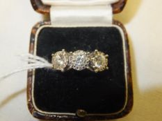 An 18 carat white gold three stone illusion set diamond ring, each stone approx 0.2 carats and