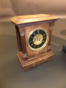 A circa 1900 French oak cased mantel clock, the two train eight day movement with visible escapement