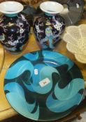 A pottery plate by Jane Cox titled "Aquitaine" with stylised swirling turquoise and dark green