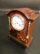 A circa 1900 mahogany and inlaid cased dome top mantel clock, the eight day movement with circular