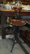 An early 20th Century copper and wrought iron spirit kettle on ornate pedestal stand