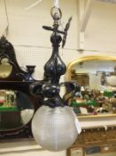 An Art Nouveau black painted iron pedant light fitting with heavy spherical globe   CONDITION