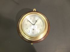 A mid 20th Century English brass cased ship's clock, the silvered dial with Arabic numerals and