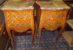 A pair of modern kingwood veneered and marble top bombé bedside chests in the Louis XVI taste
