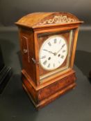 A Black Forest walnut and brass inlaid cased dome top mantel clock, the eight day movement with