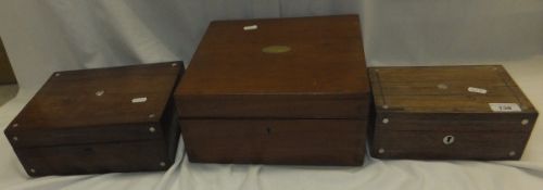 Three assorted boxes, two with mother of pearl inlay and one mahogany box with central brass oval
