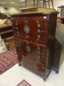 A modern Chinese lacquered chest of various drawers and doors with brass fittings