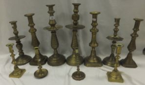 Eleven assorted brass candlesticks