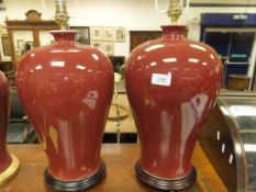 A pair of modern Chinese sang-de-boeuf baluster shaped table lamp vases and pair of lampshades