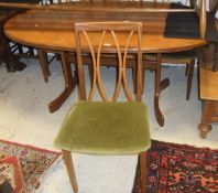 A late 20th Century teak G Plan oval extending dining table and four matching chairs