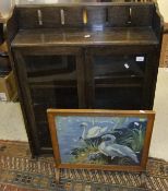 An oak bookcase, the two glazed doors enclosing two shelves, with three-quarter galleried top,