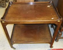A 20th century mahogany two tier trolley in the George III taste