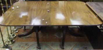 A 19th Century mahogany pedestal dining table raised on twin pedestals to tripod swept supports with