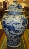 A Chinese blue and white baluster shaped vase and cover with kylin and ball decoration