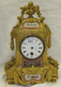 A French 19th Century brass and enamel mantel clock with Roman numerals to the enamelled dial, the