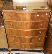 A mahogany serpentine fronted reproduction chest of five drawers with glass top, standing on