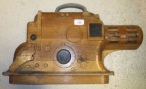 An early to mid 20th Century carved walnut half block model of a projector, bearing stamped No. "