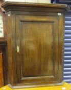A North Country oak wall mounted corner cabinet cross-banded in mahogany