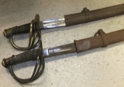 Two 19th Century Prussian cavalry sabres, each with pierced brass knuckle guard and ribbed grips,