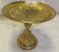 A 19th century Italian gilt metal tazza decorated with a Classical street scene with various