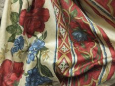 A pair of cotton lined curtains, the gold ground with red, blue and green floral pattern