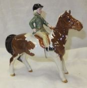 A Beswick pottery figure of a girl on a pony