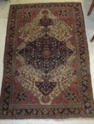 A Persian rug, the central medallion with stylised tree decoration in teal, pale red, brown and