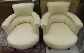 A pair of late Victorian salon chairs upholstered in cream ground fabric