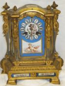 A brass and enamel mantel clock in the French taste with Roman numerals to the enamelled dial,