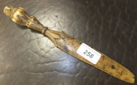 An early 20th Century treen ware letter opener with owl handle and glass eyes