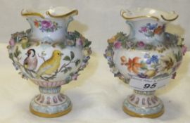 A pair of Meissen floral encrusted miniature baluster shaped vases, one painted with floral sprays