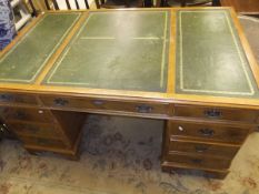 A reproduction mahogany rectangular pedestal desk, the top with tooled and gilded leather insert