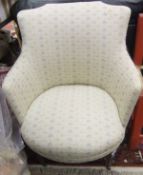A Victorian tub chair in pale foliate upholstery