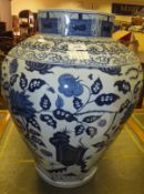 A modern Chinese octagonal baluster shaped vase with exotic bird panel decoration