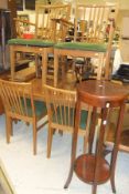 A teak extending dining table, together with six matching dining chairs, a teak sideboard with three