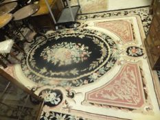 An Aubusson style stitched carpet in shades of salmon, cream, taupe and black, within a green, taupe