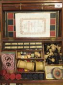 A Victorian mahogany games compedium, the mahogany case containing various associated games