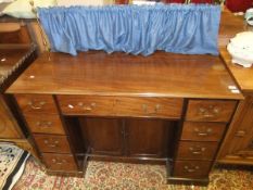 A 19th Century mahogany sideboard, the top with curtained brass rail above a central drawer above