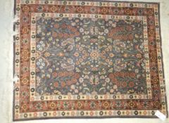 A Persian rug, the centre field with all over floral decoration in peach, cream and green, on a