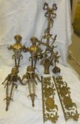 Four gilt brass furniture fittings as Eos or Nike, a gilt brass rambling rose twin branch wall light