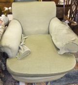 A late Victorian upholstered club style armchair on turned and ringed front legs