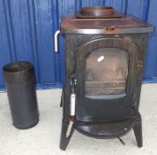A small cast iron log burner (Aspen II Multifuel Model No V0001405), a brass fire curb and a