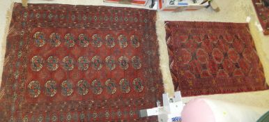 A Bokhara rug, the red centre field with repeating elephant foot medallions in red, blue and