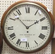 A mahogany cased circular wall clock with Roman numerals to dial marked "J. Rombach 206 Grange Road,