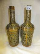 A pair of Middle Eastern pierced brass covered bottles