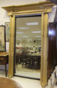 A large 19th Century mirror with mahogany frame and a gilt decorated outer frame