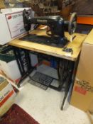 A large Singer sewing machine mounted on treadle base, bears Nos. 31K15 and EC29829