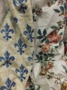 A pair of cotton interlined curtains, the neutral ground printed with blue fleur de lys pattern,